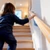 Child using a low stair handrail