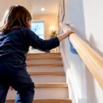 Child using a low stair handrail