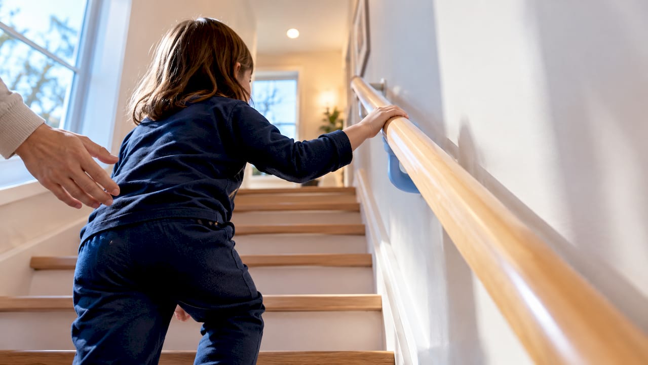 Child using a low stair handrail