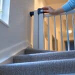Caregiver checking apartment stair gate latch