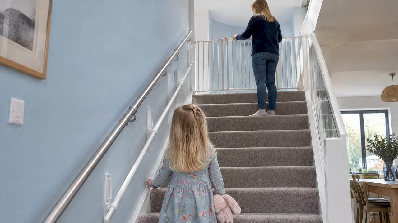 Wide staircase fitted with safety gate and child rail
