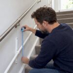 Parent measuring child stair handrail height