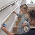 Tape measure checking child rail bracket spacing