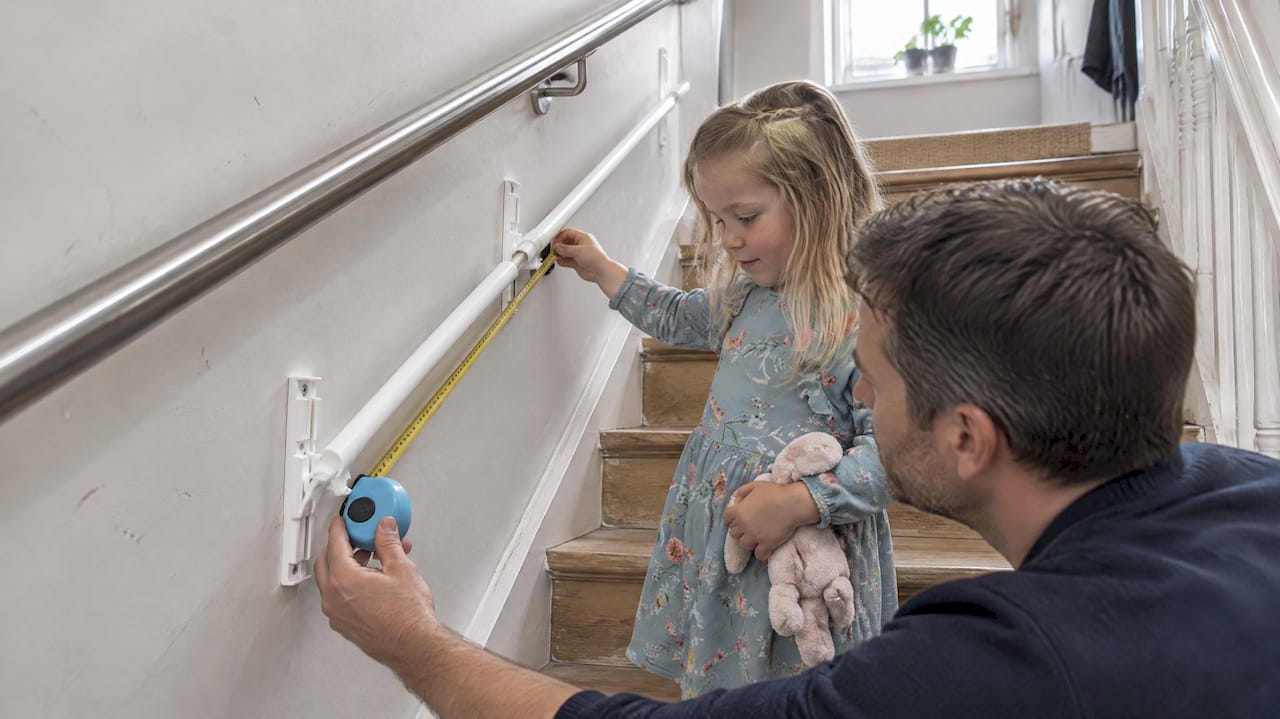 Tape measure checking child rail bracket spacing