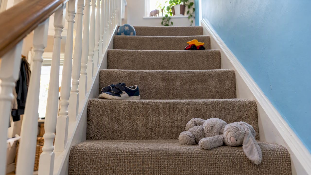 Toys and shoes scattered across stair treads